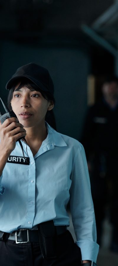 Female guard speaking on walkie-talkie